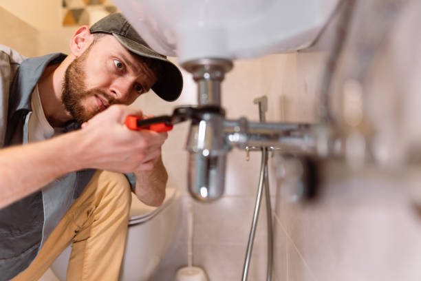 The plumber's careful approach highlights their professionalism and dedication to delivering high-quality service. They are equipped with the appropriate tools and materials, ensuring that the repair is done effectively and efficiently. The photo captures the importance of precision and attention to detail in plumbing work, as the plumber works to restore the functionality of the sink.